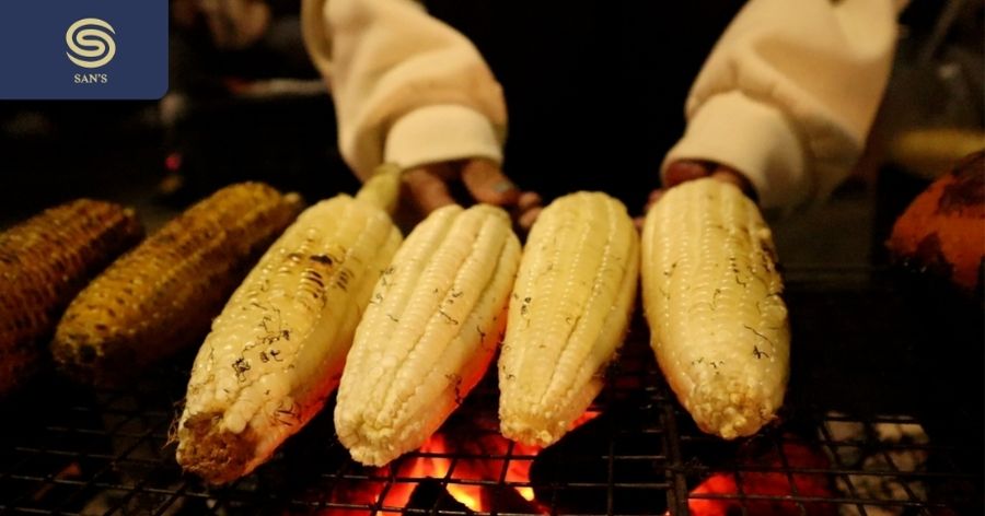 Grilled corn and sweet potatoes on the sidewalk are selling out as the weather turns cold.