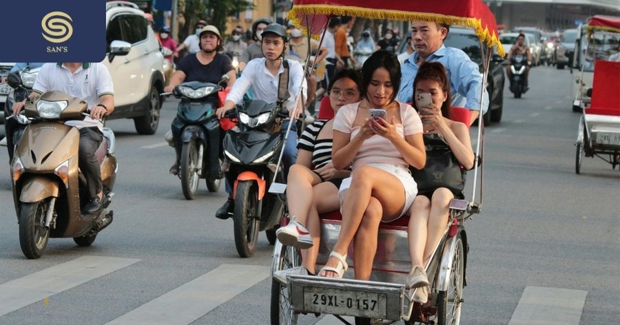 Tourists tour around Hanoi's Old Quarter by cyclo